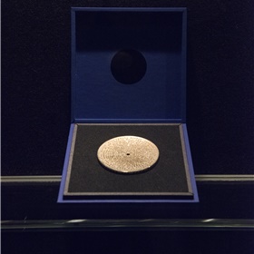 De bronzen legpenning voor de winnende auteur, een ontwerp van Irma Boom. 